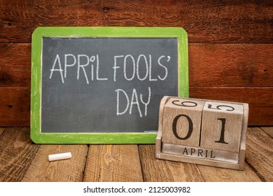 April Fools Day - white chalk handwriting on a vintage slate blackboard with wooden calendar - Powered by Shutterstock