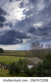 April and stormy skies over yorkshire moorland and smallholding barn