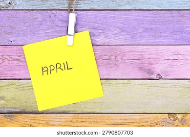april write on card on rustical wooden background 