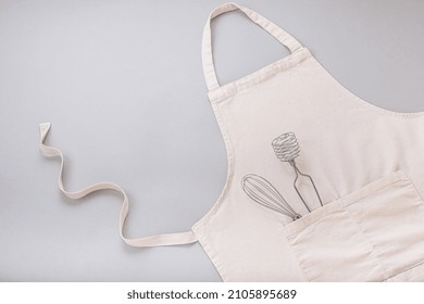 Apron and utensils baking desserts on a gray background. flat lay, top view. High quality photo - Shutterstock ID 2105895689