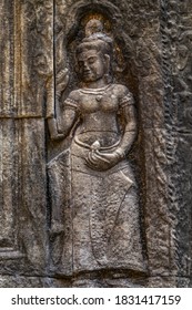 Apsara Khmer dance Stone Carving Sculpture on the wall. Relief of devata at Angkor Wat temple facade carving. Siam Reap Cambodia in Angkor Wat complex.