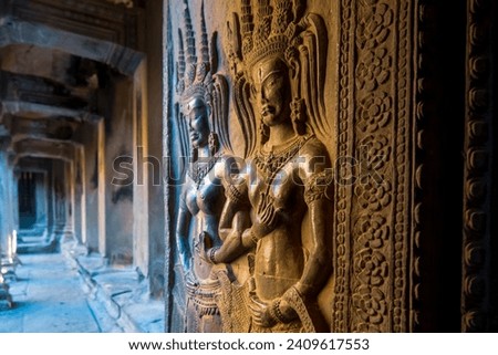 Apsaras rock carvings (celestial nymphs) on a pillar.  on historic Angkor Vat Temple in Cambodia.