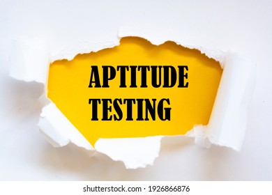 Aptitude Testing message written under torn paper.