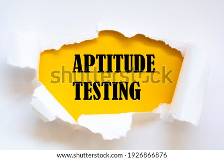 Aptitude Testing message written under torn paper.