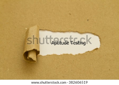 Aptitude Testing message written under torn paper.