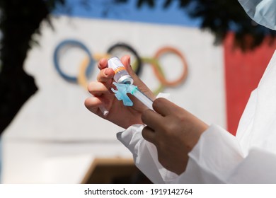 Apucarana, Paraná, Brazil - February 17, 2021 - Health Professional Prepares Syringe With Coronavirus Vaccine (COVID-19) In The Apucarana Sports Gymnasium, At The Background Of The Olympics.