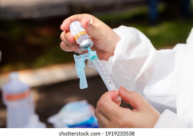 Apucarana, Paraná, Brazil - February 17, 2021 - Health Professional Prepares Syringe With Coronavirus Vaccine (COVID-19) At The Sports Gym In Apucarana.