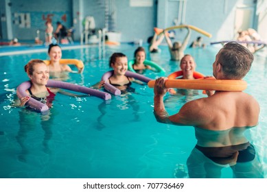 Aqua aerobics exercises, women with male trainer