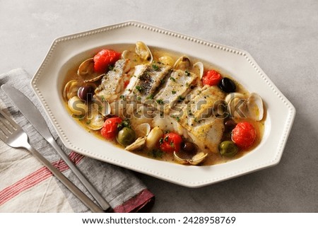Aqua pazza made with cod, clams and garlic