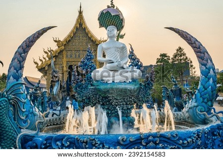Aqua tiled pool with small fountains,at sunset,surrounded by decorative blue,gree and gold ornamentation,intricate detailed engravings,sculptures and artwork.