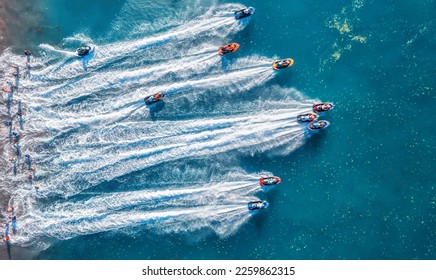 Aquabike championship on Jarun lake, Zagreb Croatia. Aerial view of the speed watercrafts in clear blue water at sunset in summer. Top view from drone of fast motorboats. Race. Water scooter