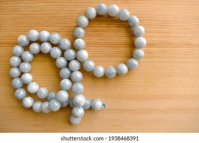 Aquamarine Bead Strand And Bracelet On Wood Background. The Blue Gemstone And March Birthstone. 