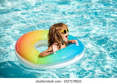 Aquapark Summer Vacation. Boy In Swiming Pool. Happy Kid On Inflatable Rubber Circle