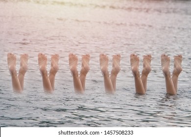 Aquatic Synchronised Swimming In The River Concept. Girl Swimmers Dance Legs.