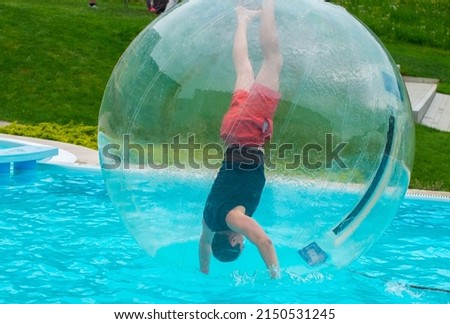 Aquazorbing  - man handstanding in the water globe