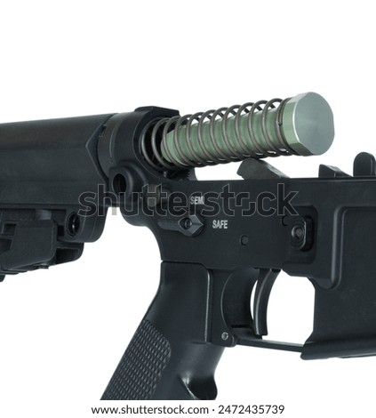 AR-15 buffer weight and buffer spring coming out of the lower receiver isolated in a studio shot.