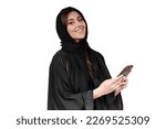 Arab abaya woman happy using mobile phone excited smile. Saudi or Emirati businesswoman.