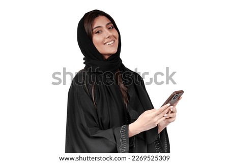 Arab abaya woman happy using mobile phone excited smile. Saudi or Emirati businesswoman.