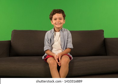 Arab boy on sofa playing game
