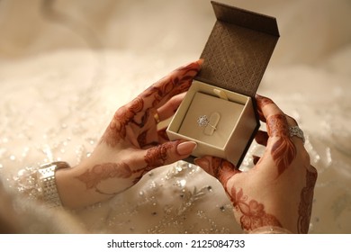 Arab bride looking at wedding ring. 