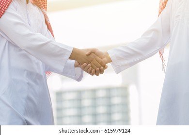 Arab Business handshake and business people on city background - Shutterstock ID 615979124
