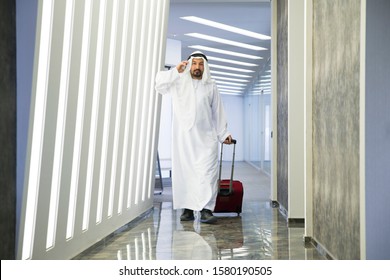 Arab Business Man Talking On Smart Phone Traveling Walking Inside In Airport.