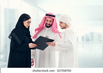 Arab Business People In A Meeting, Three Business People Standing In A Modern Office Interior Discussing Work, Ethnic Business People, Business Team.