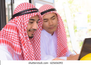 Arab Businessman Are Consulting In A Cafe, Coffee Sop.