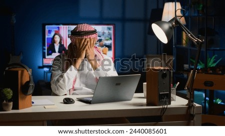 Arab businessman suffering migraine working from home while using laptop Self employed Middle Eastern man in personal apartment office answering emails getting headache from overworking