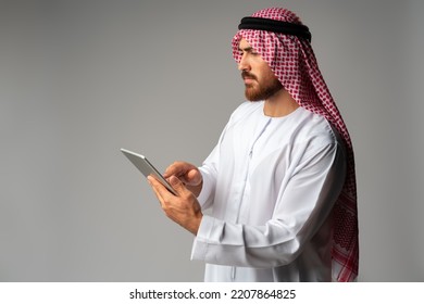 Arab Businessman Using Digital Tablet On Gray Background