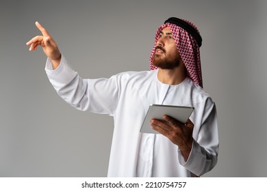 Arab Businessman Using Digital Tablet On Gray Background