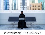 Arab businesswoman with laptop muslim wearing abaya in business background can also be Arabian student working