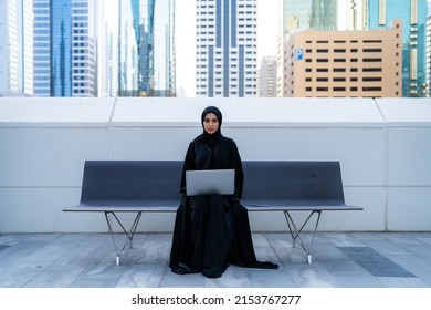 Arab businesswoman with laptop muslim wearing abaya in business background can also be Arabian student working