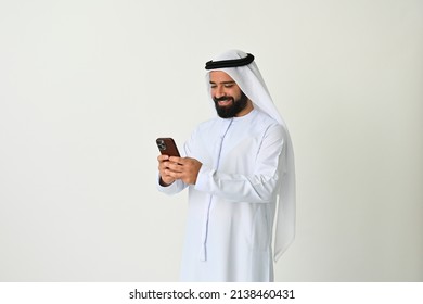 Arab Emirati Man Texting In UAE Using Mobile Phone And Sending Or Receiving Messages Maybe Making A Business Call