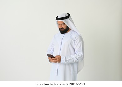 Arab Emirati Man Texting In UAE Using Mobile Phone And Sending Or Receiving Messages Maybe Making A Business Call