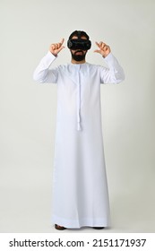 Arab Emirati Man VR Headset Enjoying Virtual Reality Wearing Traditional Isolated On Solid White Background