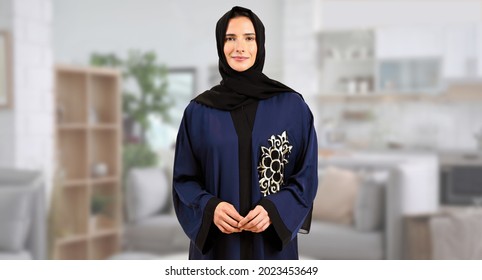Arab Emirati woman at home wearing cultural outfit ideal for mother or wife concept. Middle Eastern in Abaya and Hijab