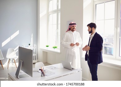 Arab And European Business People Are Standing Together In A Modern Office.