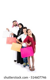 Arab family shopping and standing in raw