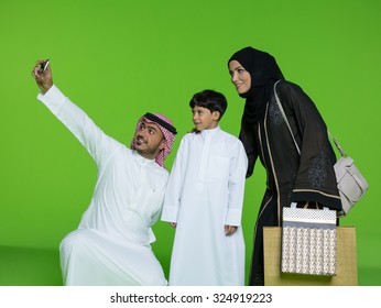 Arab Family Taking Selfie Using Mobile Camera