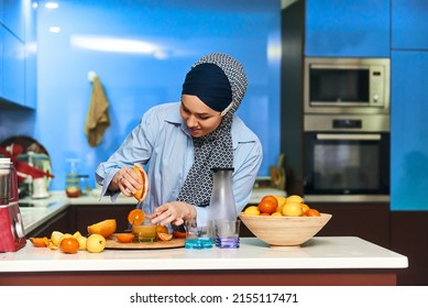  Arab hijab woman making fruit juice in the modern kitchen. Home concept. Healthy lifestyle concept. Selective focus. High quality photo. - Powered by Shutterstock