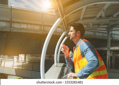 Arab, Indian Worker Man Smoking Cigarette, Take A Rest Near Workplace Before Go Back To Work In Hot Weather. Handsome Young Guy Smoke At No Smoking Area That Employee Male Can Not Smoke. Stressed Guy