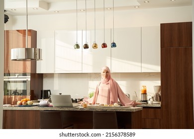 Arab Islamic Woman Standing In Kitchen With Modern Interior