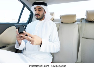 Arab Local Business Man Using Smart Phone While Inside A Car