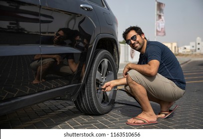 Arab Man Adding Air Into Car Tyres