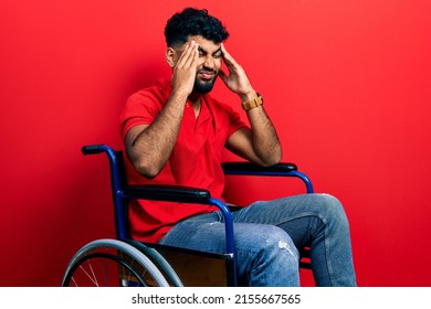 Arab man with beard sitting on wheelchair with hand on head, headache because stress. suffering migraine. 