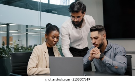 Arab Man Coach Leader Boss Talking About Mistake Explain Indian Teacher Mentor Teaching Interns Managers Employees Use Online App Help With Software Diverse Team Looking Laptop Discussing Project