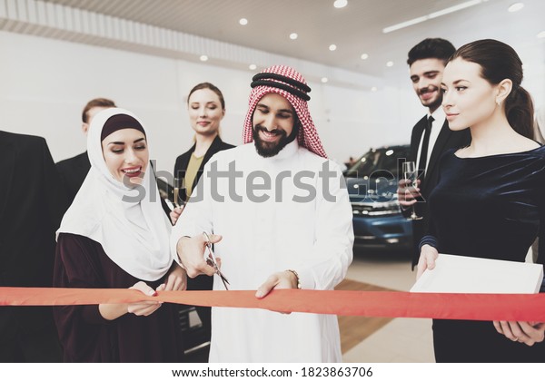 Arab man cuts ribbon to open new car\
dealership. The team is looking at the Arab who cuts the tape to\
open a large car\
dealership.