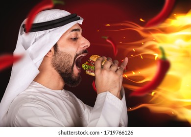 Arab Man Eating Spicy Burger With Burning Fire And Hot Red Chili. Fast Food Ads.