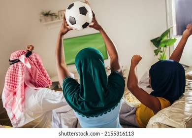 Arab Man Looking TV At Home During A Sport Event With His Family. Watching Football Game.